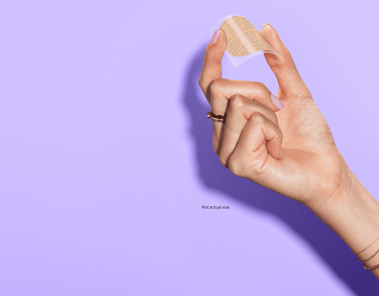 A hand holding the Gwyn Lo birth control patch